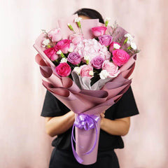 Bouquet bunga mawar merah muda dan ungu dari online florist, dikemas cantik dengan pita ungu